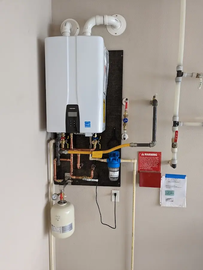 Professional plumber installing copper piping in a Middle River home